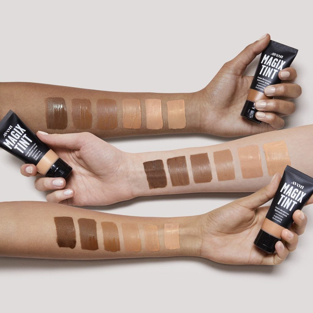 Three arms with different skin tones showing swatches of the MagiX Tint Tinted Moisturizer