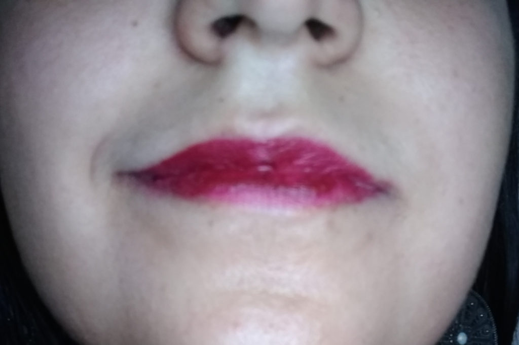 Close up of lips showing Mattitude liquid lipstick in the shade Persistent