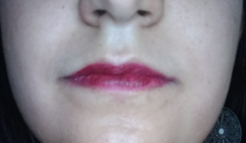 Close up of lips showing Mattitude liquid lipstick in the shade Persistent after a few hours of wear
