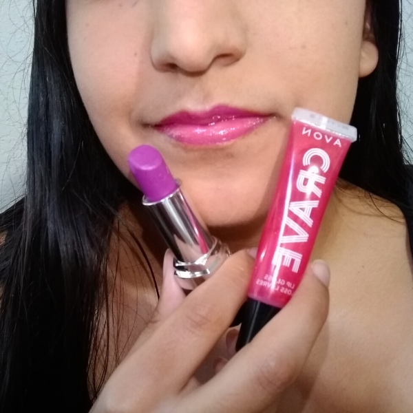 lower half of a woman's face showing crave lip gloss in the shade Cherry Creamsicle over true color lipstick in the shade Hot Plum