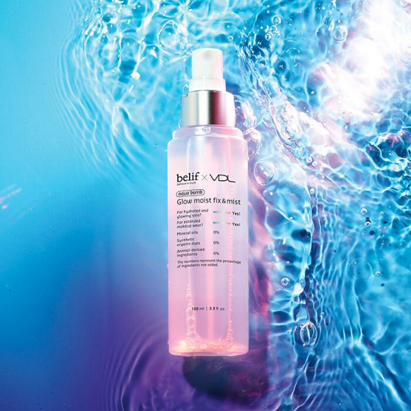 Bottle of belif x VDL Moist Glow Fix & Mist, in front of a water-filled blue and purple background