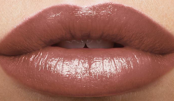 Close up of a woman's lips showing True Color Nourishing Lipstick in the shade Brown Sugar