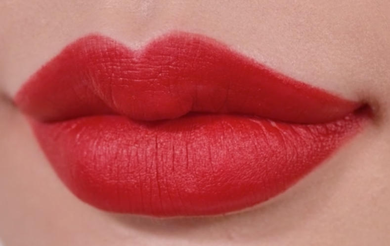 Close up of a woman's lips showing Flat Velvet Lipstick in the shade Darjeeling Red