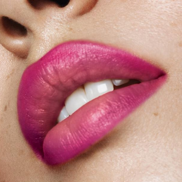 Close up of a woman's lips wearing the Flat Two-Tone lipstick in the shade Purple with Beige