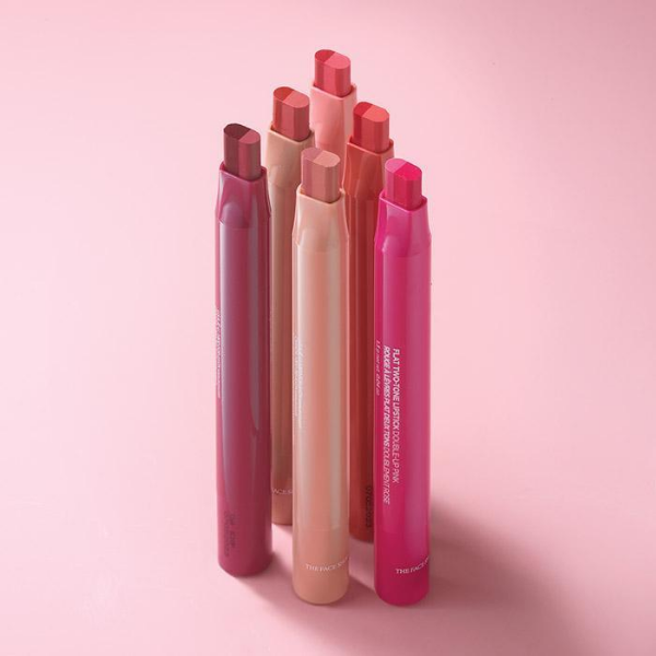 6 tubes of Flat Two-Tone Lipsticks arranged in a huddle, against a light pink background