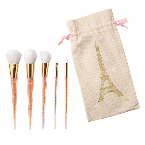 all 5 brushes in the Dazzle Me Makeup Brush set and the accompanying Eiffel Tower bag, against a white background