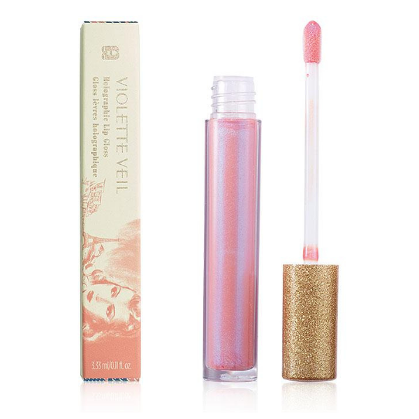 Open Tube of Violette Veil Holographic Lip Gloss next to its vintage-style box, against a white background