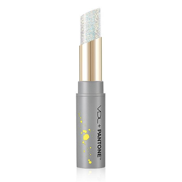 Open tube of VDL x Pantone Expert Ultimate Glitter Lip Balm with limited edition grey and yellow packaging, against a white background