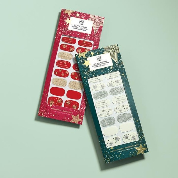 Two packages of Glimmer nail stickers, one of each color option, sitting on a light green surface
