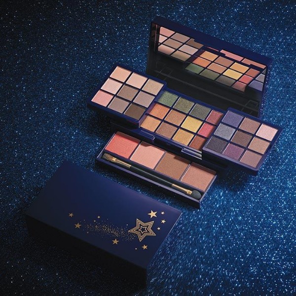 Open package of Glimmer Glow Up, Glim Up Mega Palette sitting on a dark blue sparkle surface