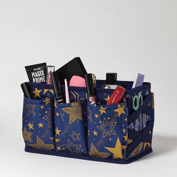 Glimmer Beauty Caddy with a dark blue and gold star print, against a light grey background