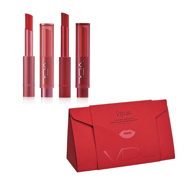 Two open tubes of VDL Expert Slim Lip Color Matte standing next to their caps, above a bright red origami-style gift box