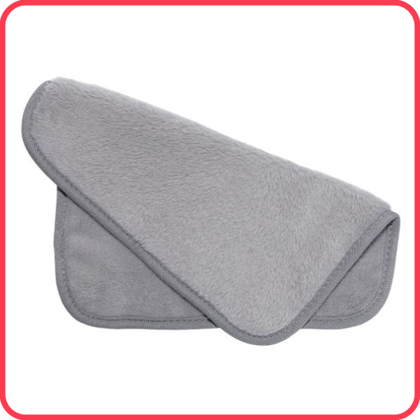 Grey makeup remover cloth that is slightly folded at an angle to show the texture on both sides, against a white background and with a bright red-pink border