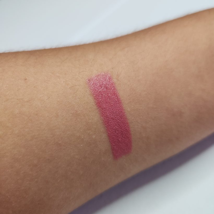 Arm swatch showing the shade Aster in Avon's Glimmer Satin Lipstick