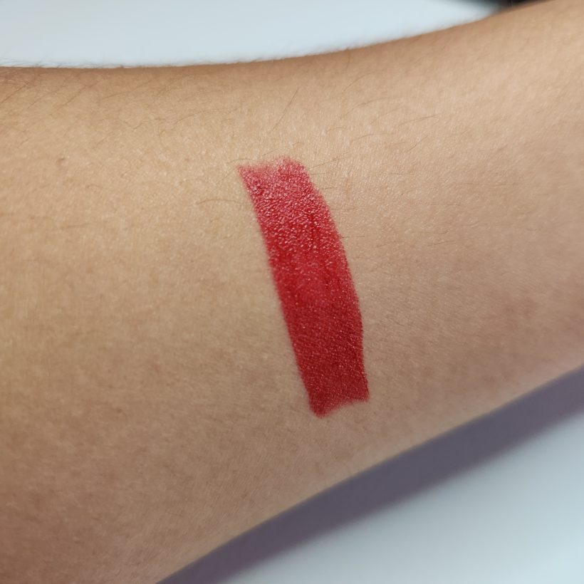 Arm swatch showing the shade Firebolt in Avon's Glimmer Satin Lipstick