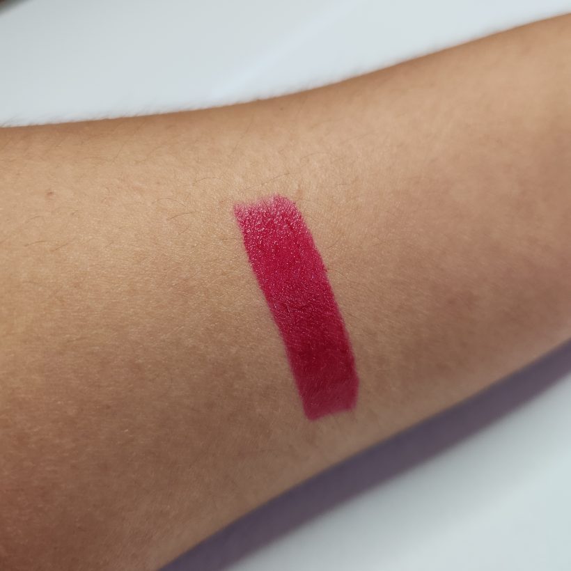 Arm swatch showing the shade Hibiscus in Avon's Glimmer Satin Lipstick