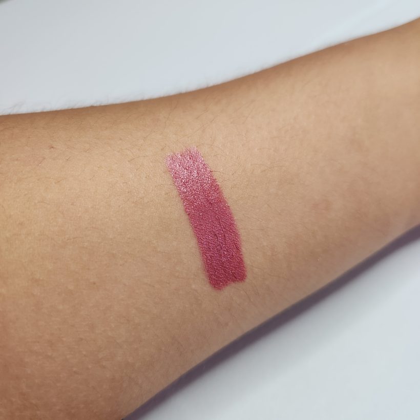 Arm swatch showing the shade Plum Blossom in Avon's Glimmer Satin Lipstick