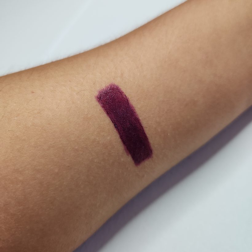 Arm swatch showing the shade Violet Night in Avon's Glimmer Satin Lipstick