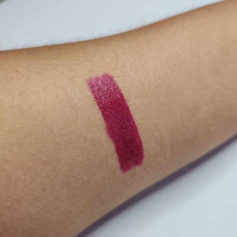 Arm swatch showing the shade Wild Cherry in Avon's Glimmer Satin Lipstick