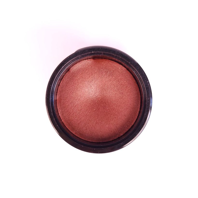 Open tub of Cashmere Multi-Balm in the shade Cranberries, against a white background