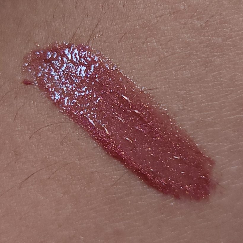 Arm swatch showing Glimmer Lip Gloss in the shade Bronzeberry