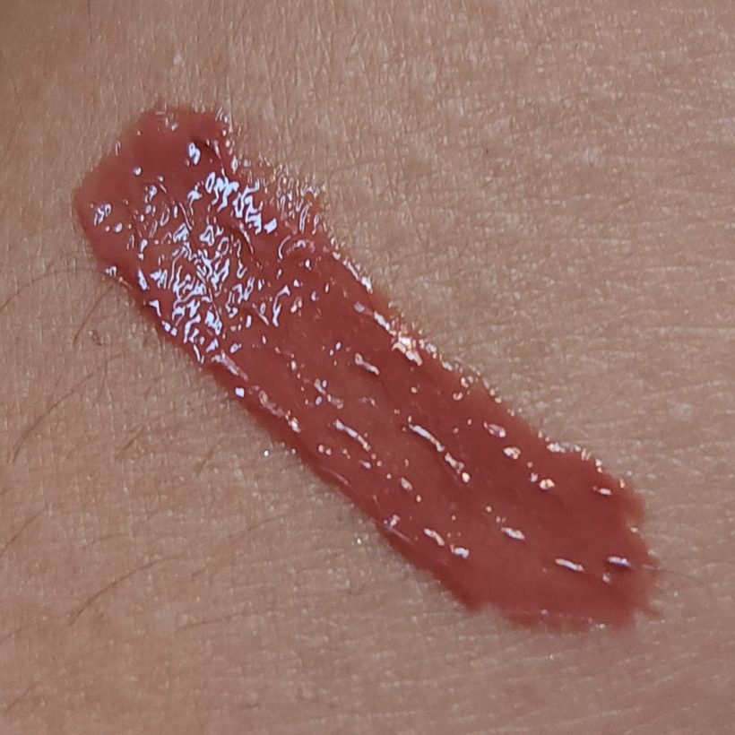 Arm swatch showing Glimmer Lip Gloss in the shade Buttered Rum