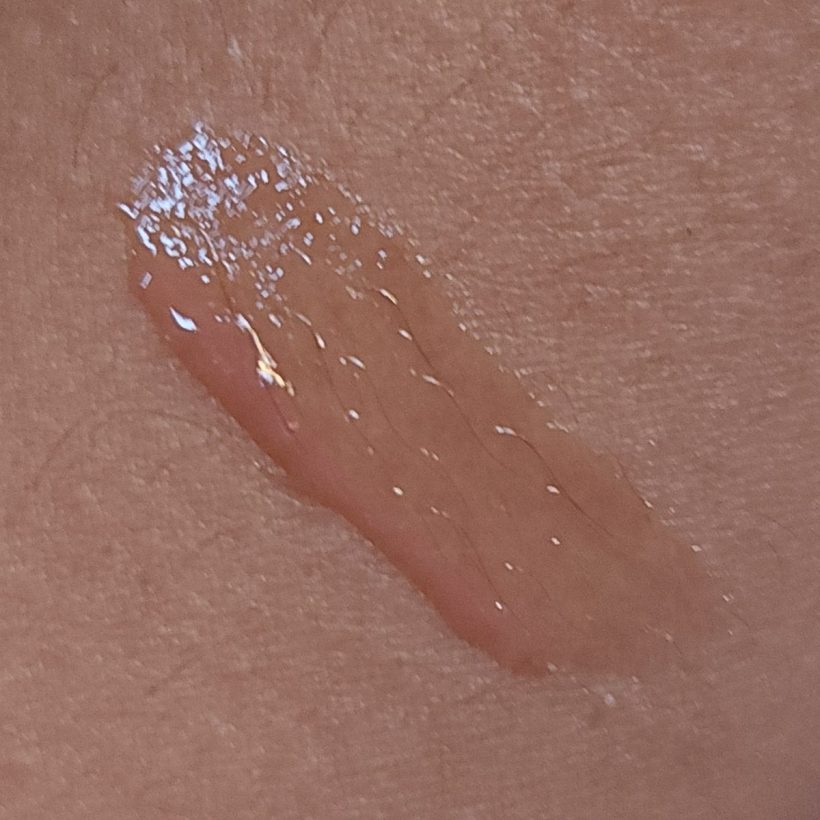 Arm swatch showing Glimmer Lip Gloss in the shade Cha Cha Cha