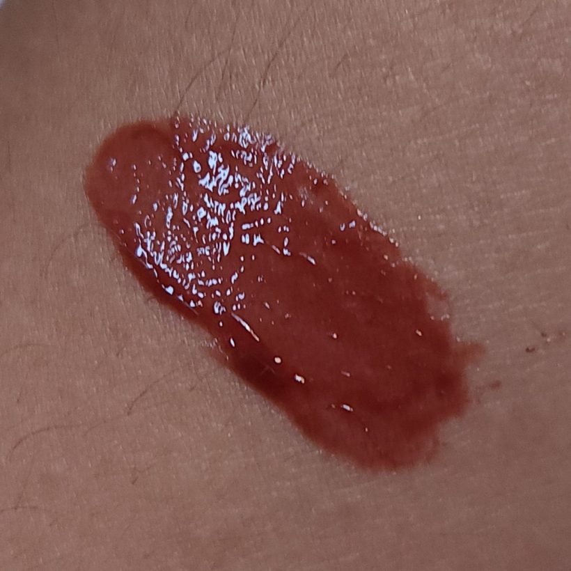 Arm swatch showing Glimmer Lip Gloss in the shade Siren
