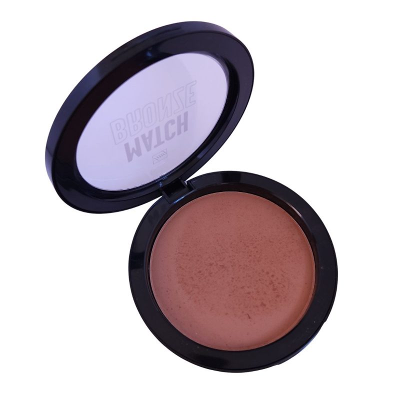 Open compact with warm medium tan makueup and black packaging, against a white background